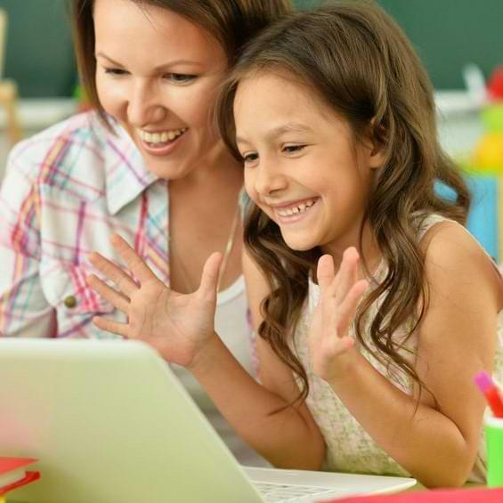 Teacher And Girl Student Smiling At Laptop